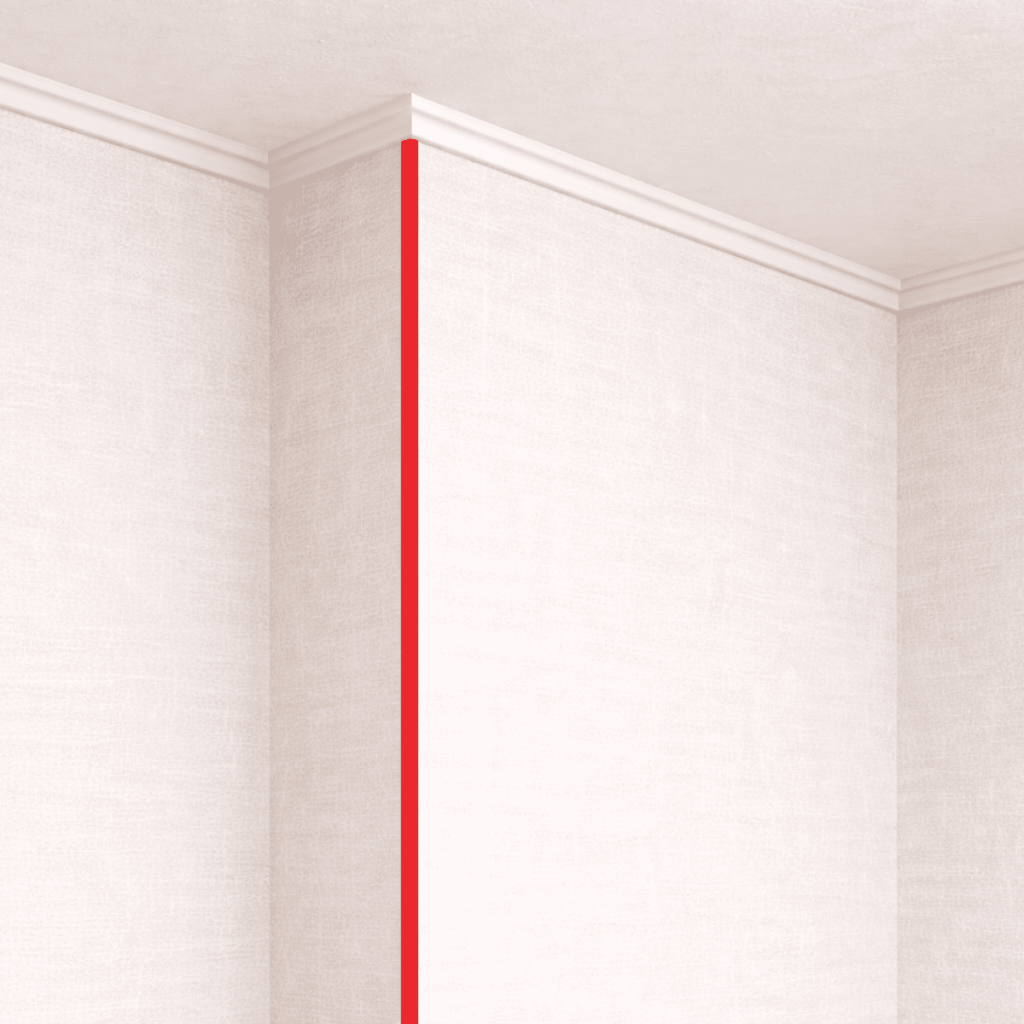 2面の壁紙が外側に突き出る出隅部分に沿って、赤いラインで角の位置が強調された室内コーナーの様子